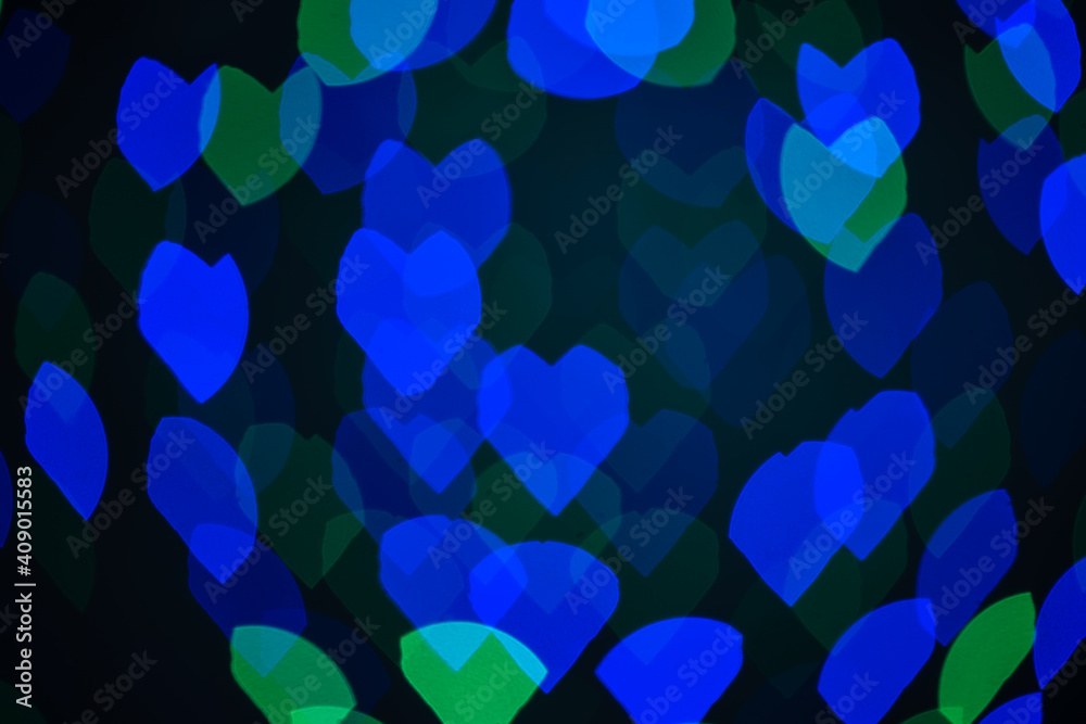 Multicolored blurred hearts, bokeh, lights on a black background, a symbol of love for Valentine's Day. Multicolored blurred hearts, bokeh, lights on a black background, a symbol of love for Valentine's Day.