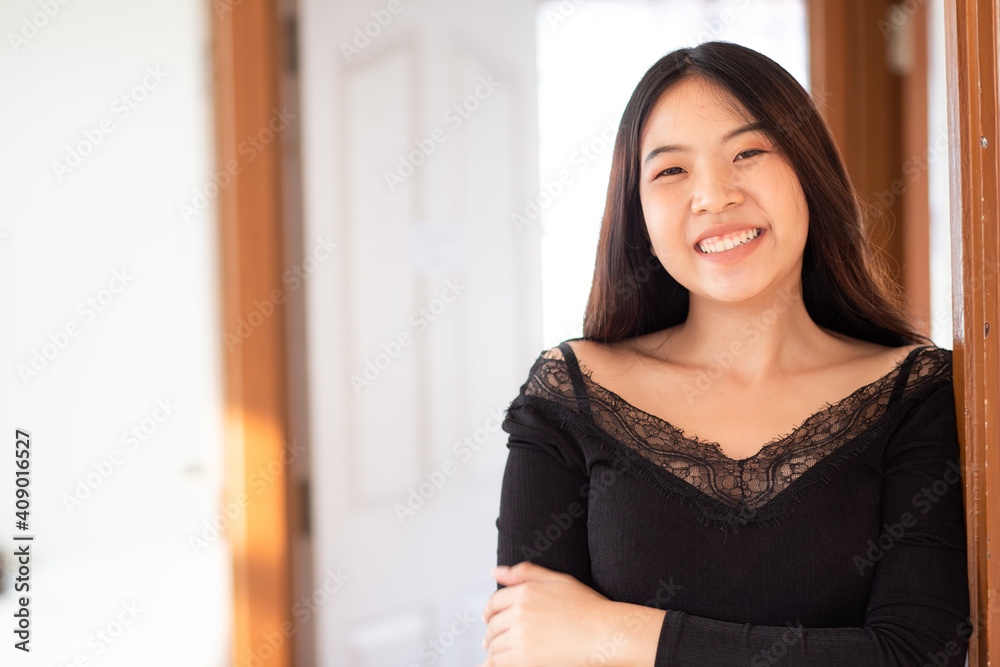 Smilinng sexy asian women stand posting in livinngroom cozy house
