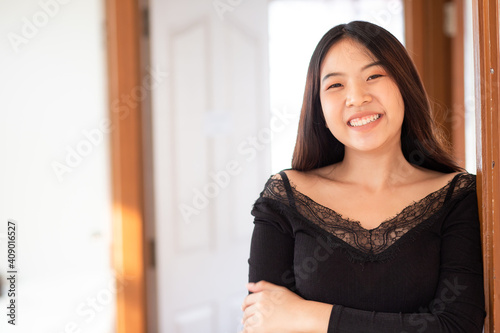 Smilinng sexy asian women stand posting in livinngroom cozy house