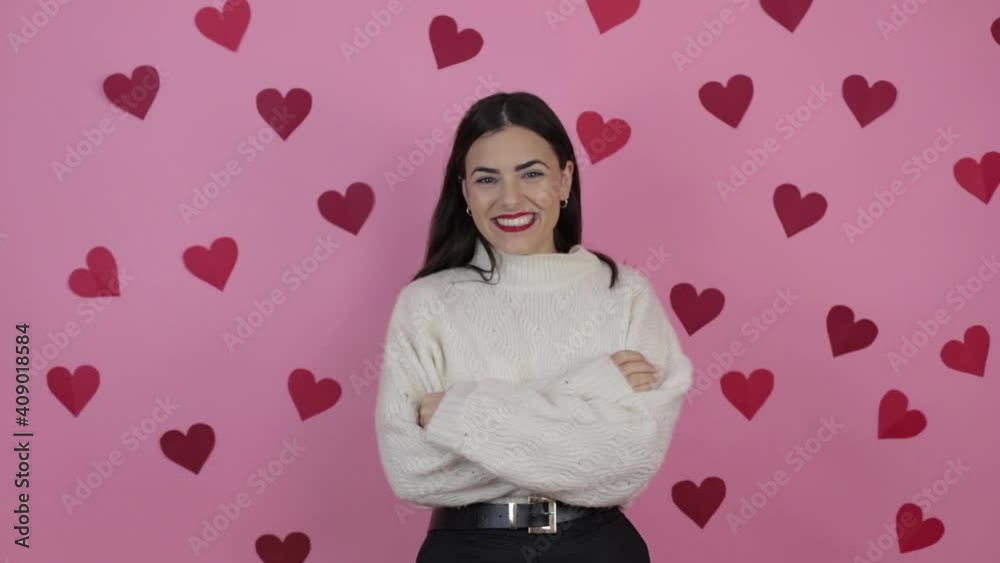 Young beautiful woman very happy making a heart in the air with fingers Young beautiful woman very happy making a heart in the air with fingers