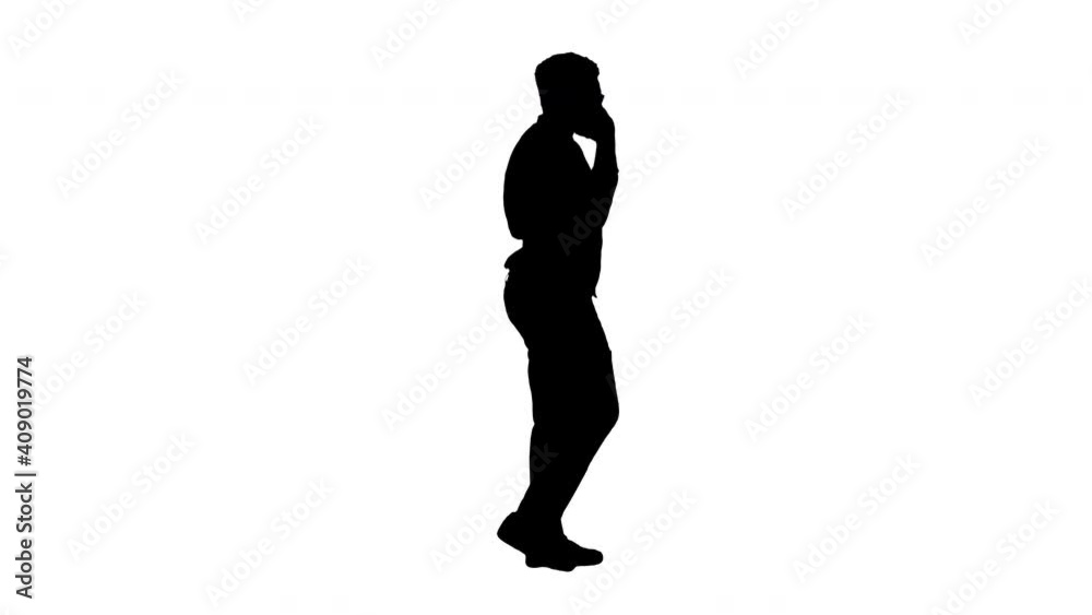 Silhouette Smiling young african american business man talking on the phone while walking. Silhouette Smiling young african american business man talking on the phone while walking.