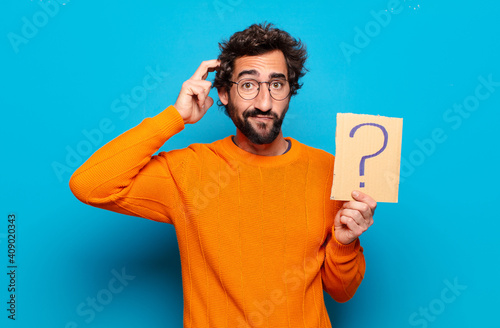 Fotografie young bearded man with a question mark symbol