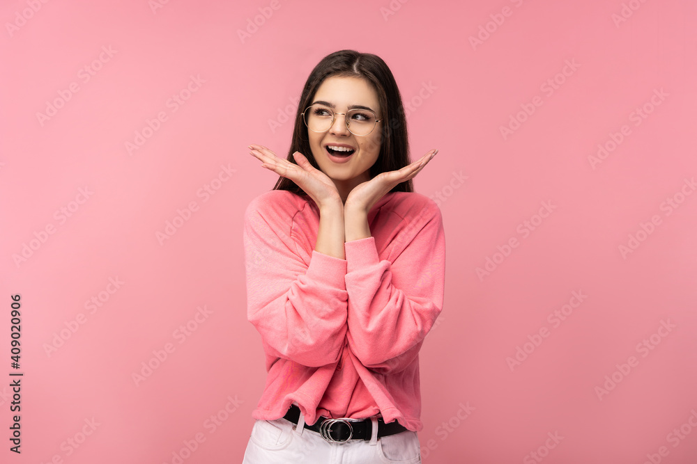 Photo of attractive woman in glasses smile surprised and wonder wear casual pink t-shirt white pants isolated pink color background Photo of attractive woman in glasses smile surprised and wonder wear casual pink t-shirt white pants isolated pink color background