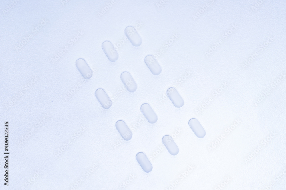 image of white tablets on a white background . image of white tablets on a white background .
