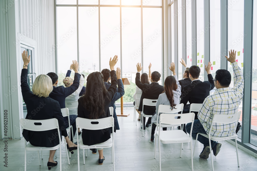 Professional business are raising their arms during meeting in office together at the office.