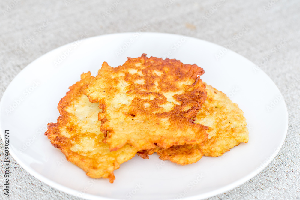 Potato pancakes, raggmunk, draniki, deruny, latkes or boxties on white plate. Potato pancakes, raggmunk, draniki, deruny, latkes or boxties on white plate.