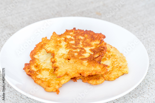 Potato pancakes, raggmunk, draniki, deruny, latkes or boxties on white plate.