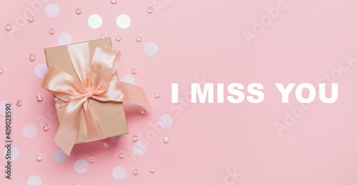Gifts on pink background, love and valentine concept with text I miss you © Daria Lukoiko