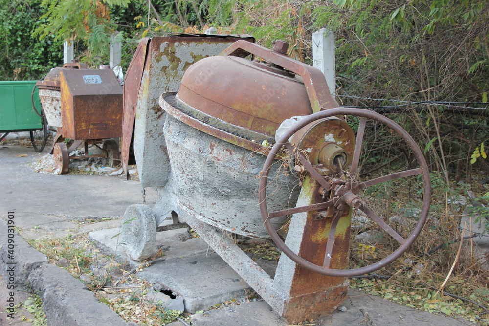 Old and rusty concrete mixer unusable. Old and rusty concrete mixer unusable.