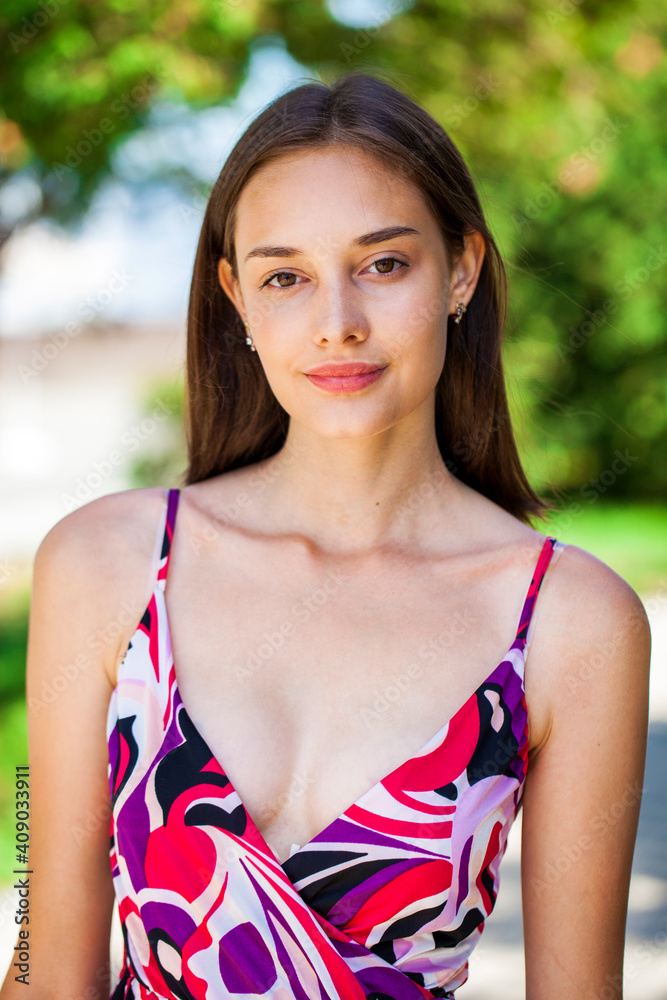 Close up portrait of a young beautiful woman in flowers dress Close up portrait of a young beautiful woman in flowers dress
