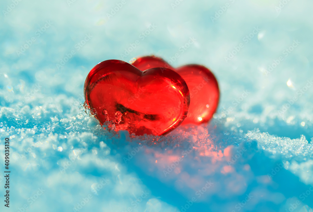 Fototapeta premium valentine's day greeting card with festive background with two transparent red love symbols hearts on blue snow