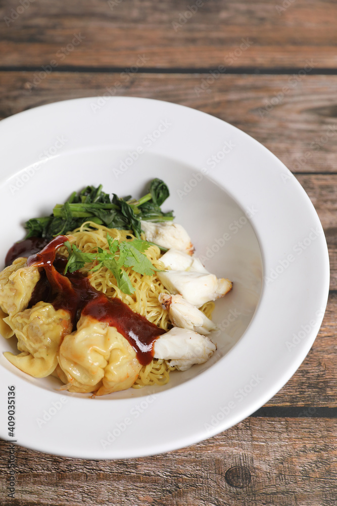 Shrimp dumpling noodles and crab meat on wood background Shrimp dumpling noodles and crab meat on wood background
