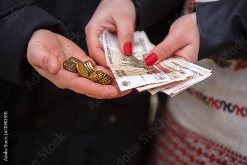 Wallpaper Mural People hold Russian coins and banknotes in their hands. Money close-up. Torontodigital.ca