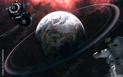 Fototapeta Naklejka Na Ścianę i Meble -  Planet Earth with rings. Astronaut out of focus. Space station blurred in motion. Solar system. 3D Render. Science fiction. Elements of this image furnished by NASA