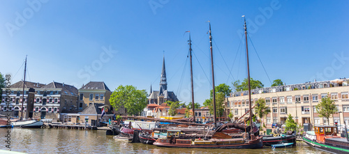 Panorama of old wooden sailing ships in the harbor of Gouda, Netherlands photo