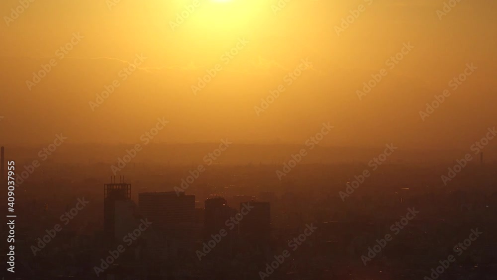 TOKYO, JAPAN : Aerial high angle sunset CITYSCAPE of TOKYO and MOUNT FUJI. Huge sun sinking behind mountains. Japanese city life and nature concept. Long time lapse tracking shot dusk to night. TOKYO, JAPAN : Aerial high angle sunset CITYSCAPE of TOKYO and MOUNT FUJI. Huge sun sinking behind mountains. Japanese city life and nature concept. Long time lapse tracking shot dusk to night.