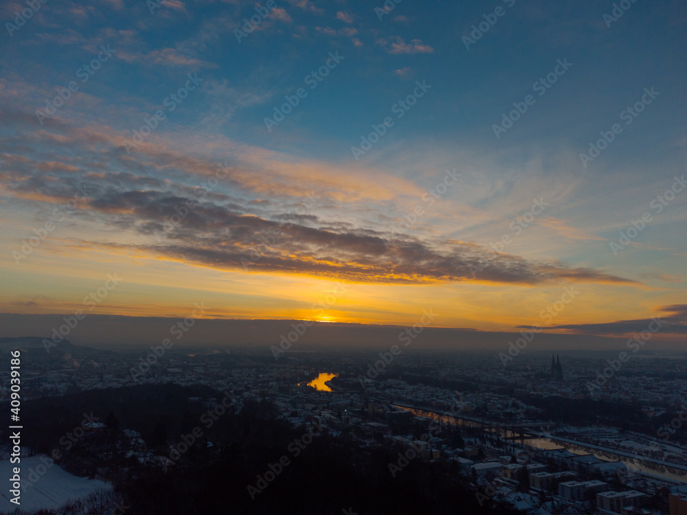 Aerial drone view of Regensburg in Bavaria with snow during sunrise on clear cold winter day