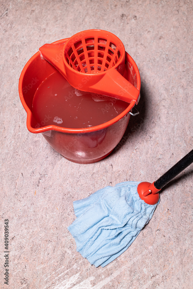 above view of mop cleaning linoleum flooring near red bucket with dirty water at home above view of mop cleaning linoleum flooring near red bucket with dirty water at home