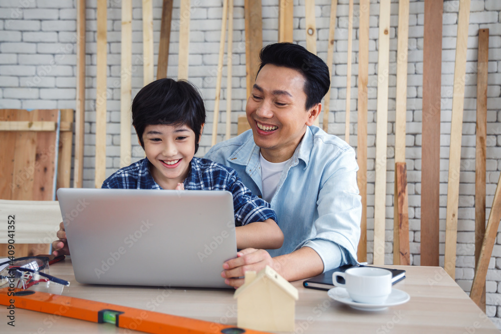 Asian father and son using laptop computer together. Asian father and son using laptop computer together.