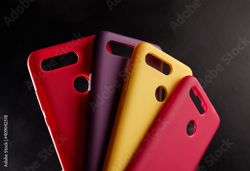 colorful cases for modern smartphones stand on stands on the table one object in focus blurred background