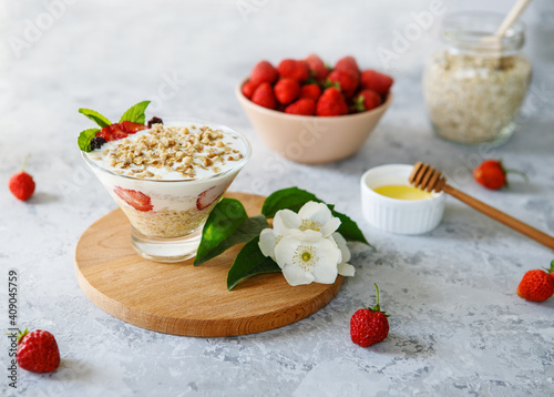 A dietary dessert made from oatmeal and fresh strawberries. Delicious healthy, light breakfast. Panna Cotta. Granola with yoghurt. The right sweets. Vegetarian sweets