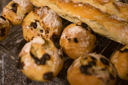 Homemade breads : French baguettes and small round hard breads with chocolate chips.