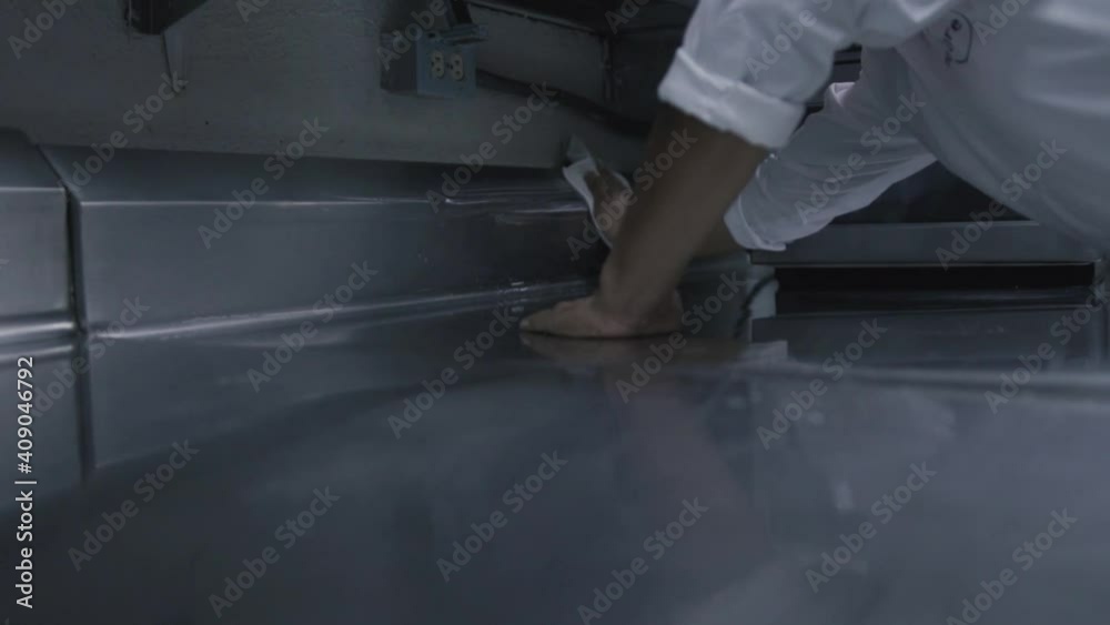 Manos de un hombre limpiando y sanitizando una cocina