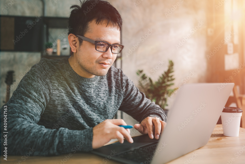 Asian man working with computer laptop. concept work form home, online education, e-learning, stay at home. freelance life style, new normal life style, covid-19 pandemic, after coronavirus outbreak. Asian man working with computer laptop. concept work form home, online education, e-learning, stay at home. freelance life style, new normal life style, covid-19 pandemic, after coronavirus outbreak.