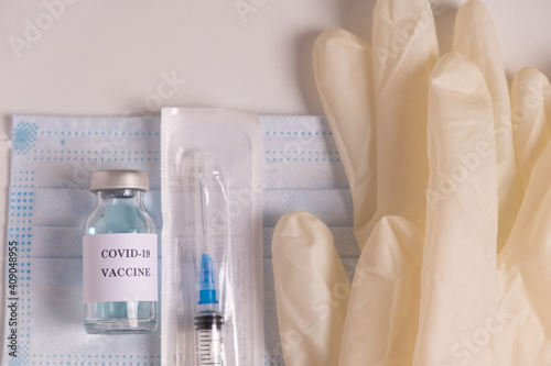 Coronavirus Vaccine, syringe injection, gloves, mask.  Ampoule with liquid medicine drug for prevention, immunization and treatment from corona virus infection (COVID-19). Medicine infectious concept