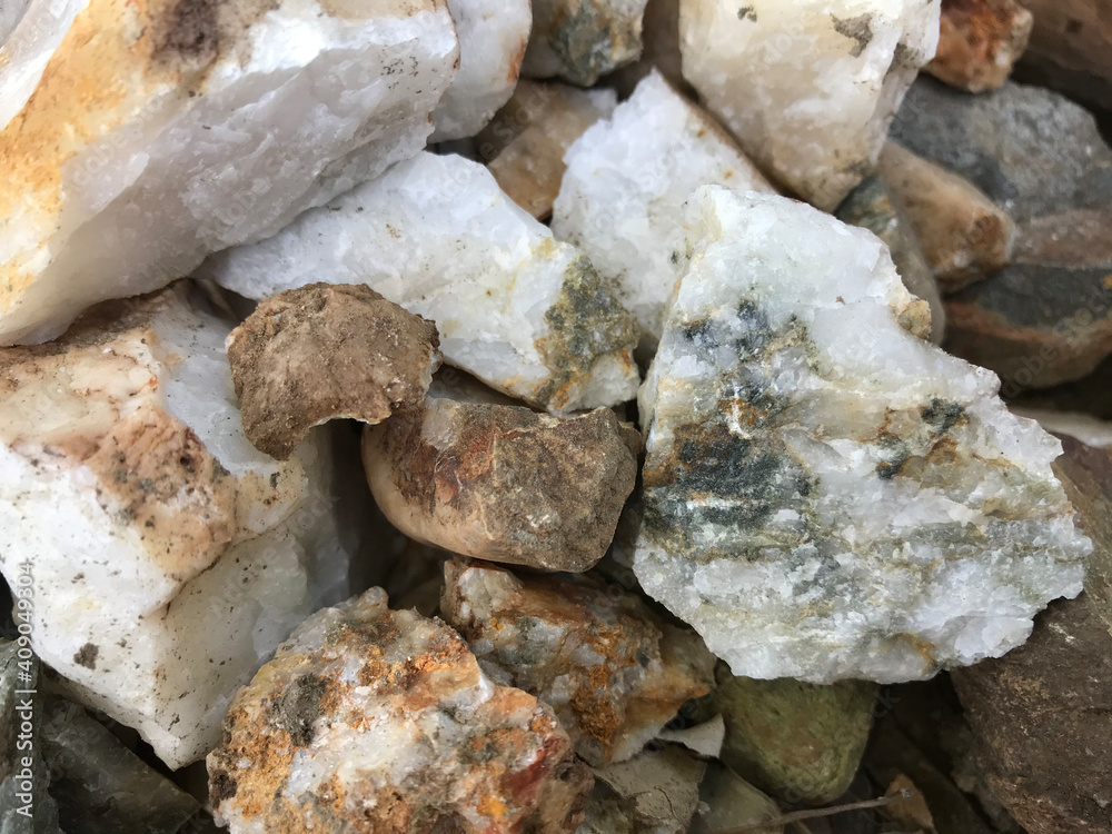 white quartz stones inlaid with minerals such as gold, silver, cilice and bronze, extracted from an artisanal mine