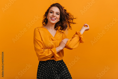 Vászonkép Front view of happy girl isolated on yellow background