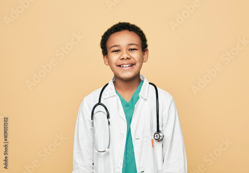 Obraz na plátne Portrait of African American little boy dressed as a doctor with stethoscope, he posing, smiling and looking at camera