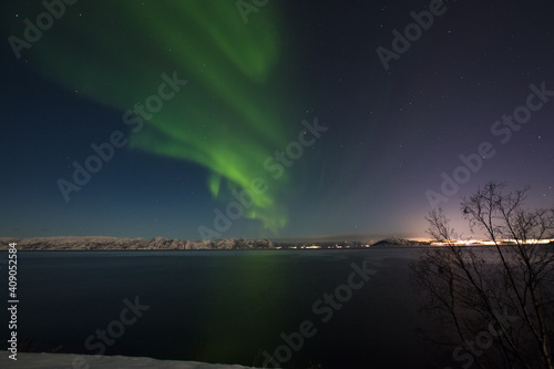 Northern lights over a bay i northern Norway