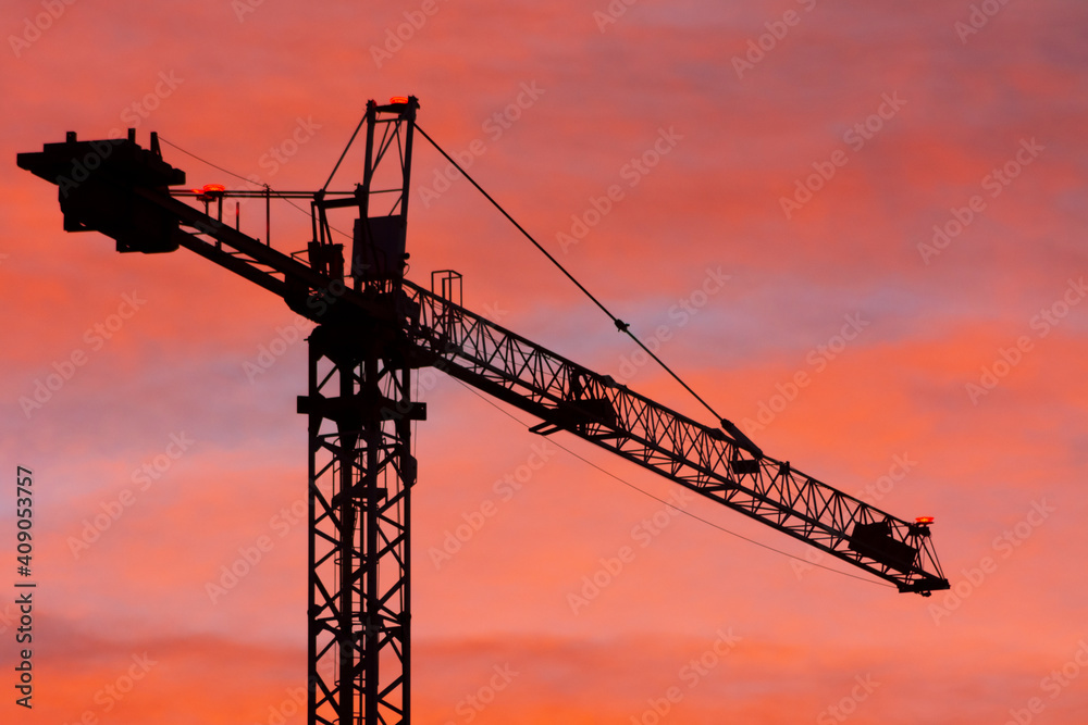Silhouette of a crane with orange sky