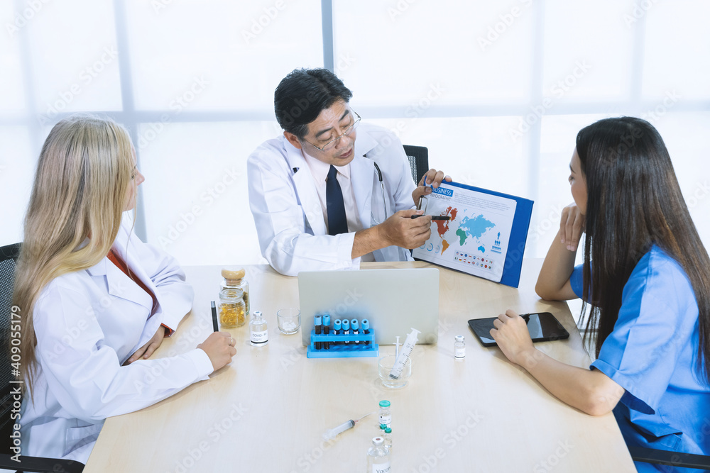 Fototapeta premium Group of doctor discussion about vaccine for healing covid-19 disease coronavirus at hospital.