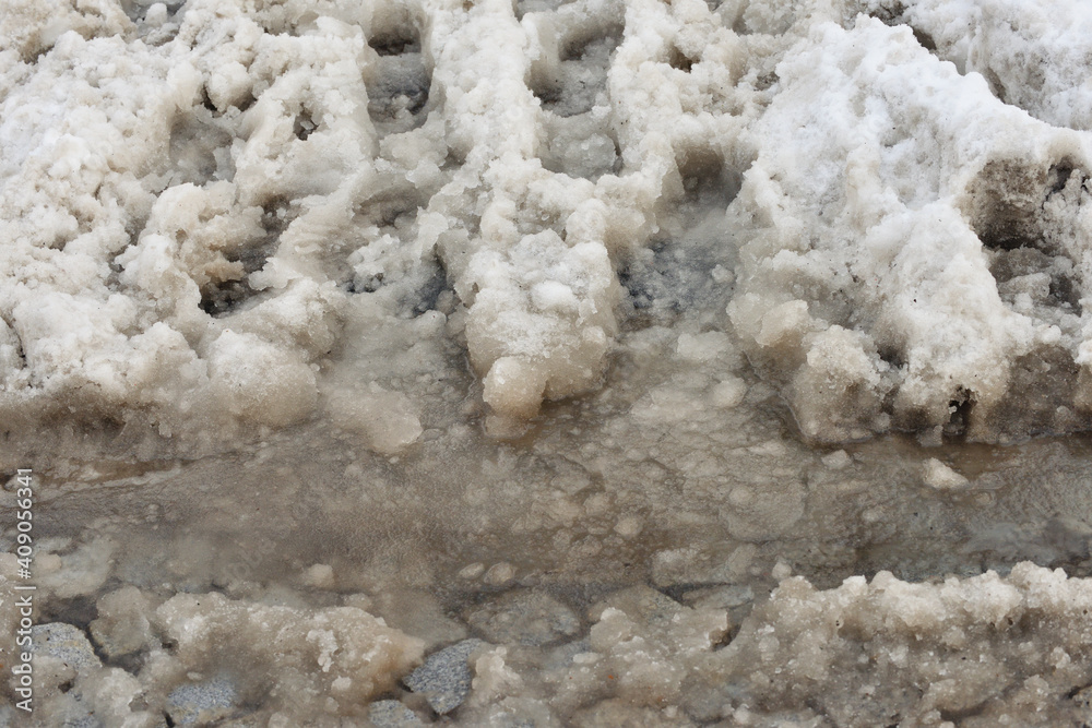 Tire and foot tracks on dirty snow, Anti-icing chemicals Tire and foot tracks on dirty snow, Anti-icing chemicals
