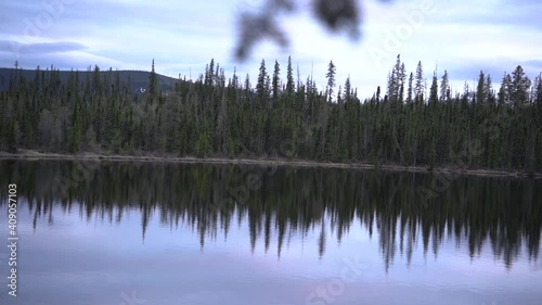 Slow pan of a lake in the Canadia Rockies surrounded by pines. photo
