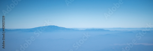 View of blue sky, cloud, mist and top of mountain using Nature landscpae cover page.