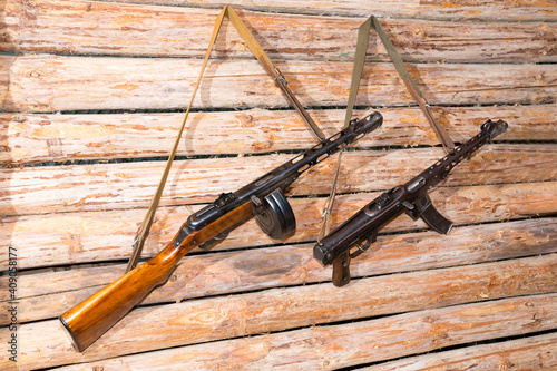 Two sub-machine gun  hang on the wall of the dugout