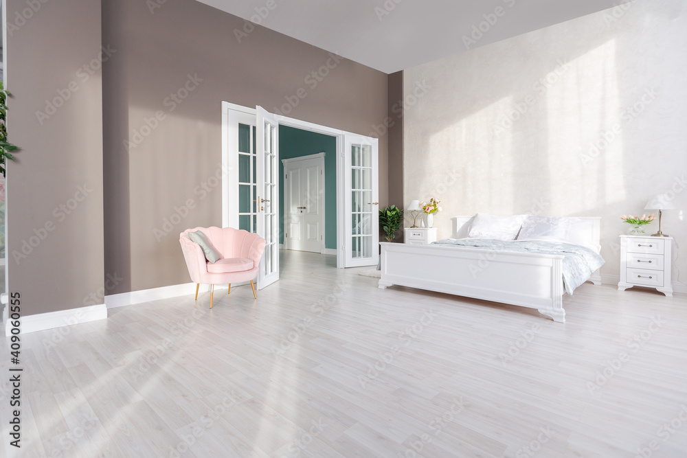 Fototapeta premium Stylish modern bedroom with a minimalistic design in a luxurious rich, expensive interior of an open-plan apartment in light colors.
