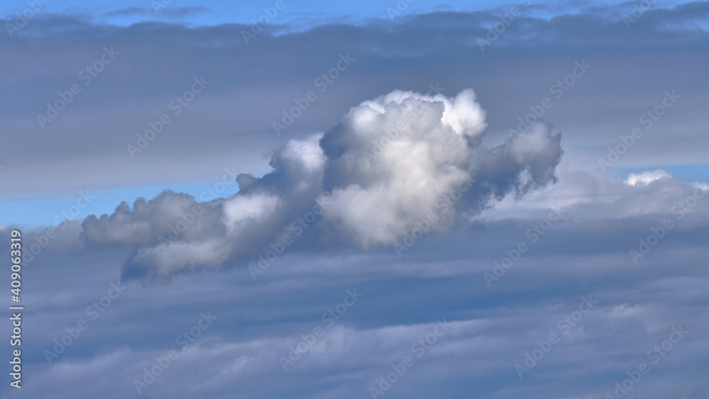 Grey and blue clouds in the sky in winter. Wind clouds