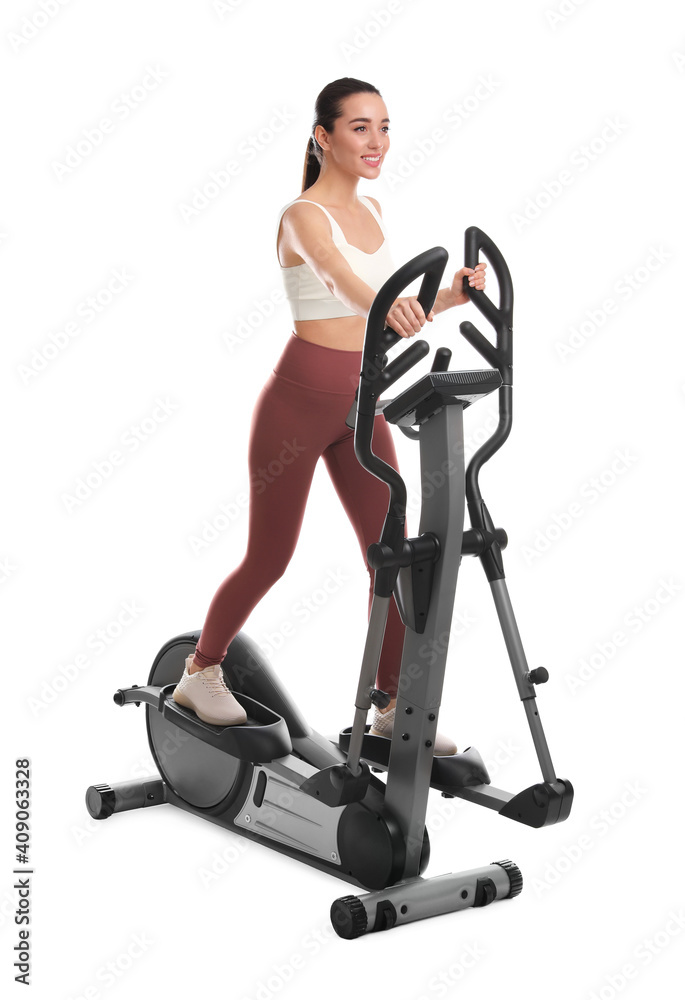 Woman using modern elliptical machine on white background Woman using modern elliptical machine on white background