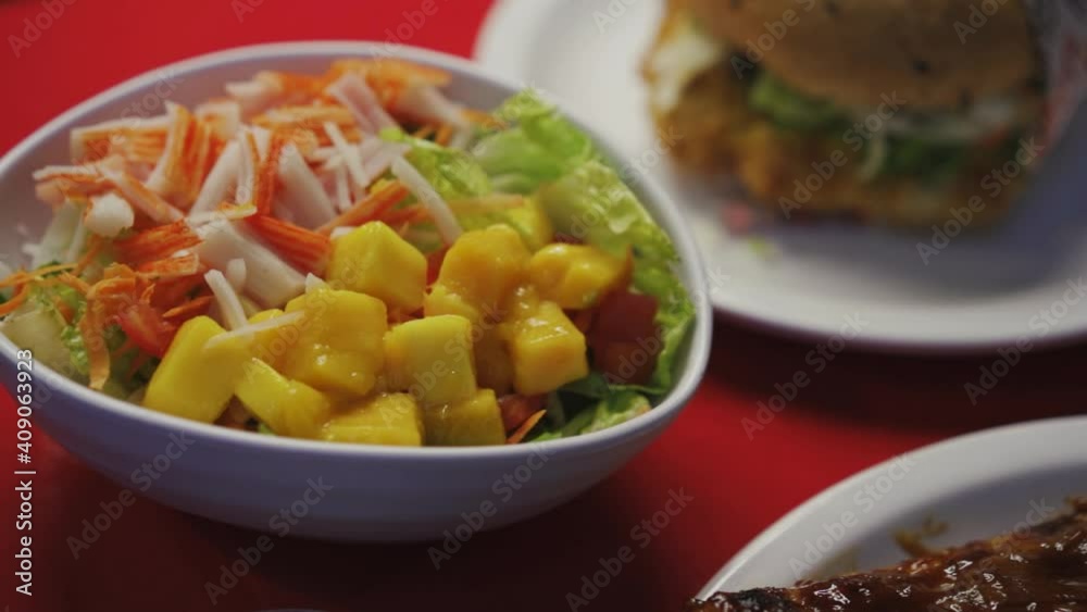 Kani Salad With Imitation Crab Meat, Lettuce, Mango, Carrots, And Sauce. - close up Kani Salad With Imitation Crab Meat, Lettuce, Mango, Carrots, And Sauce. - close up