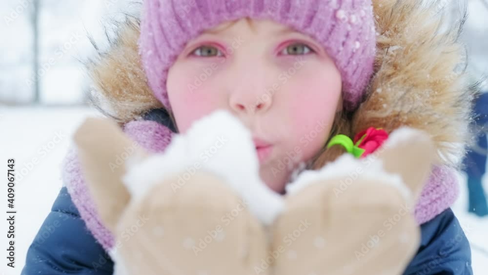 Kid blows snow. Pre teen girl blows snow into the camera Kid blows snow. Pre teen girl blows snow into the camera