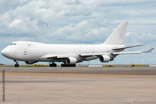 White Boeing 747 400 Freighter carrying cargo at cloudy day