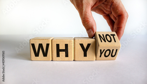 Why not you symbol. Businessman turns a cube and changes words why you to why not. Beautiful white background. Business and why not you concept. Copy space.