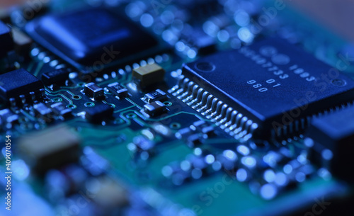 Digital microchip under dramatic blue light close-up