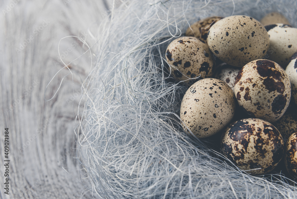Easter decoration. Quail eggs in a nest on a wooden background Easter decoration. Quail eggs in a nest on a wooden background