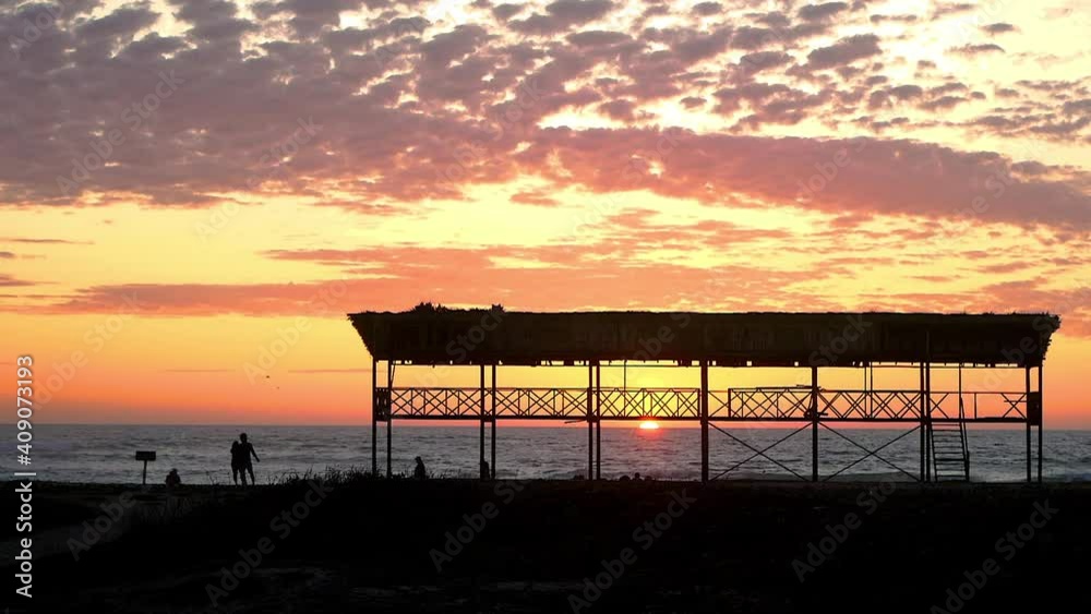 Beautiful viewpoint on the beach of Salinas - Ecuador at sunset in summer - orange sunset
