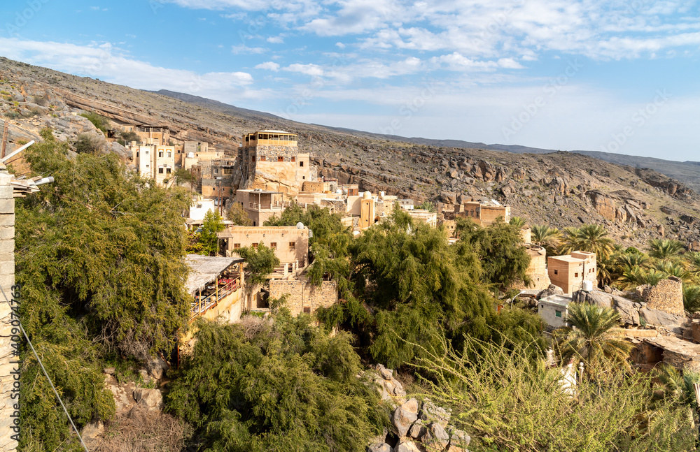 View of mountain village Misfat Al Abriyeen surrounded by the garden with date palms, Sultanate of Oman
